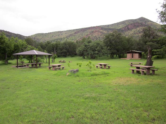 Grassy flat area with picnic tables, and one covered picnic tableWide open spaces for your gathers.