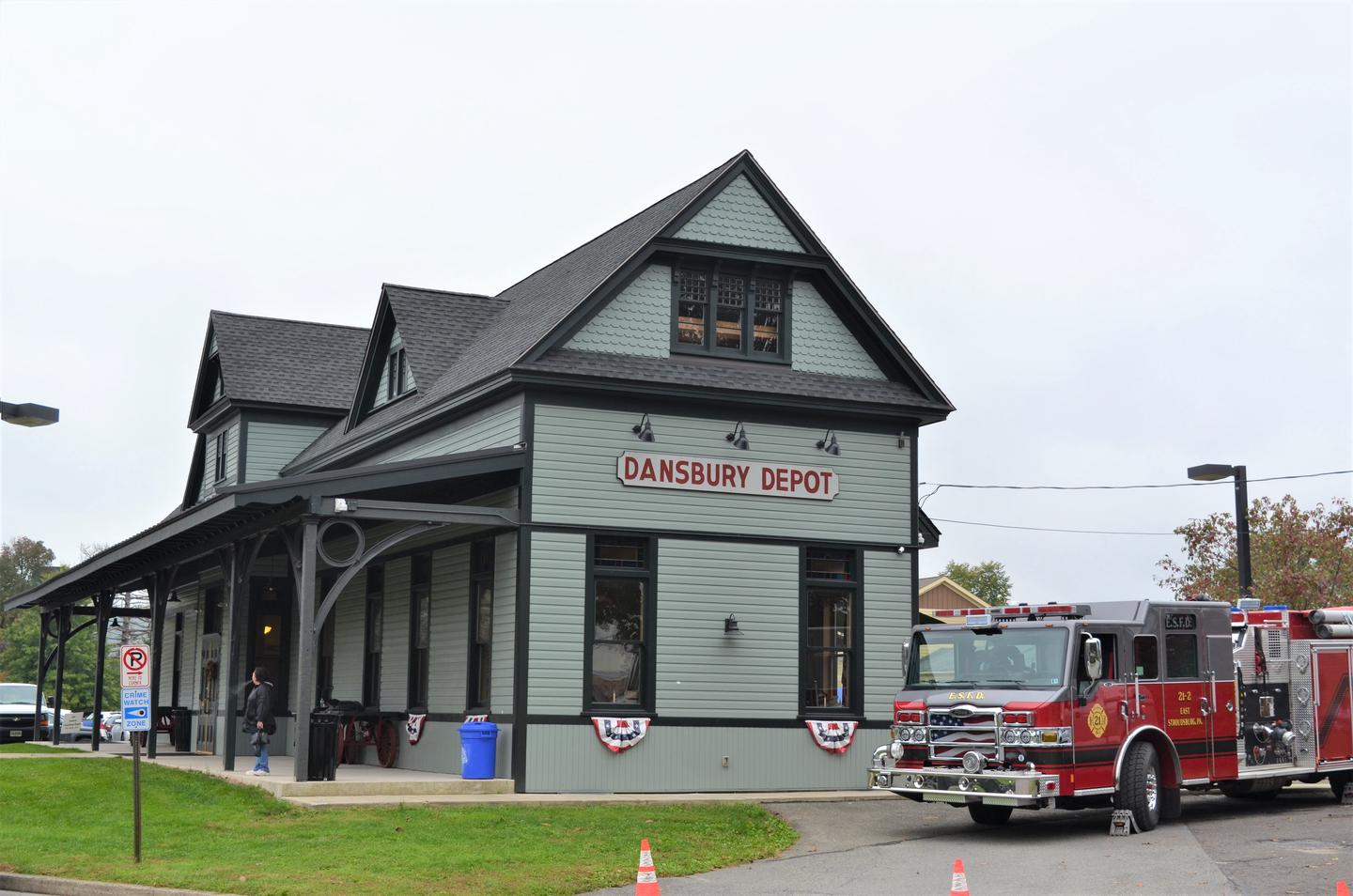 A firetruck is parked along side a train station.Dating back to 1863, the Dansbury Depot at East Stroudsburg is one of the oldest train stations to remain on the Delaware, Lackawanna and Western Railroad.