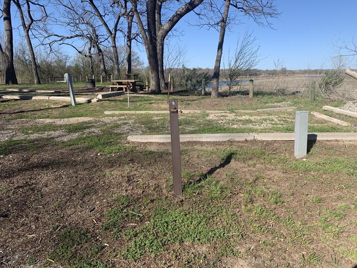 A photo of Site 9 of Loop A at Damsite Texas with Picnic Table, Electricity Hookup, Fire Pit, Water Hookup
