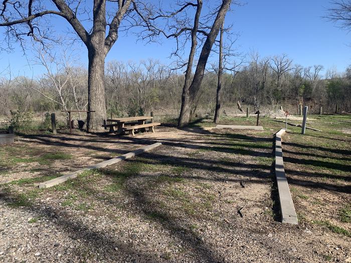 A photo of Site 10 of Loop A at Damsite Texas with Picnic Table, Electricity Hookup, Fire Pit, Shade, Water Hookup
