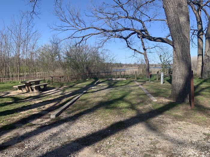 A photo of Site 11 of Loop A at Damsite Texas with Picnic Table, Electricity Hookup, Fire Pit, Shade, Water Hookup