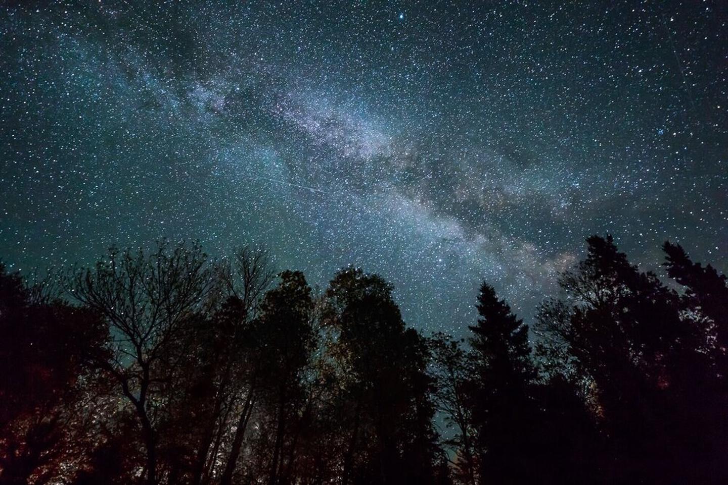 The Milky Way Galaxy stretches across the dark night sky at Voyageurs