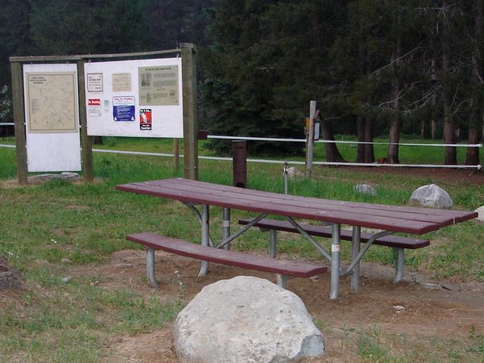 Picnic table with kiosk in background.Big Creek Campground