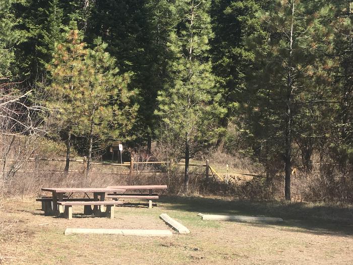 Campsite with grassy parking area and picnic table.Big Flat Campsite