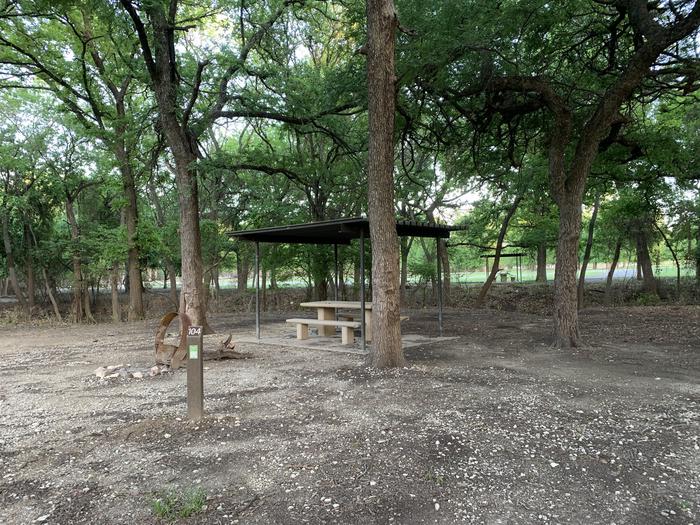 A photo of Site 104 of Loop HOLIDAY CAMPGROUND at Holiday (Texas) with Picnic Table, Fire Pit, Shade
