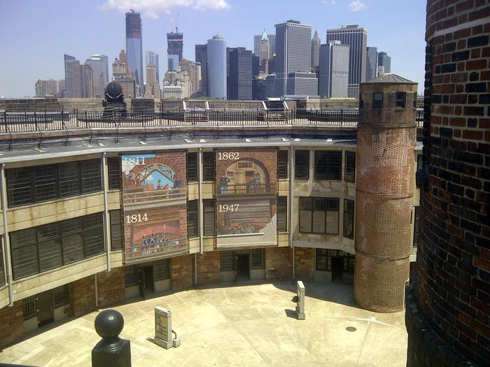 Castle williams interior court yard, showing courtyard exhibits and NYC skyline in backgroundThe courtyard of Castle Williams