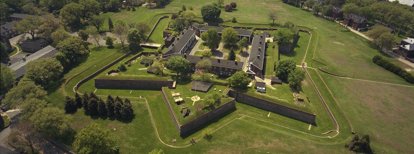 Aerial image of Fort jay, a star shape fort surrounded by green fields or glacis Fort Jay, a star shaped fort, a design perfected by the Marquis de Vauban, and used by Jonathan Williams to build the island's primary fortification