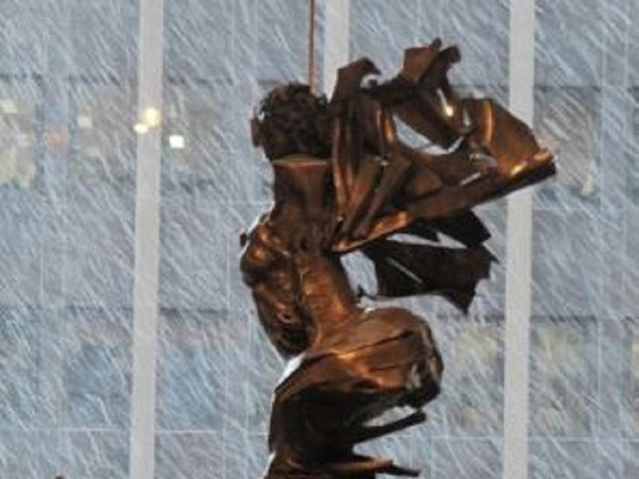 A sculpture of a woman on a ship with snow falling in the background.Africa Rising by Barbara Chase-Riboud.