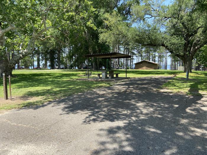 A photo of Site 084 of Loop A at MILL CREEK (TEXAS) with Picnic Table, Electricity Hookup, Fire Pit, Shade, Lantern Pole