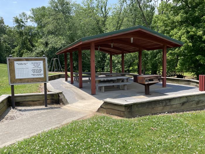 Shelter with three picnic tables.