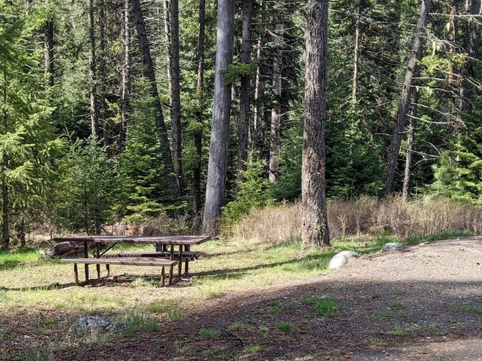Campsite with picnic table adjacent to parking area.Poverty Flat Campground