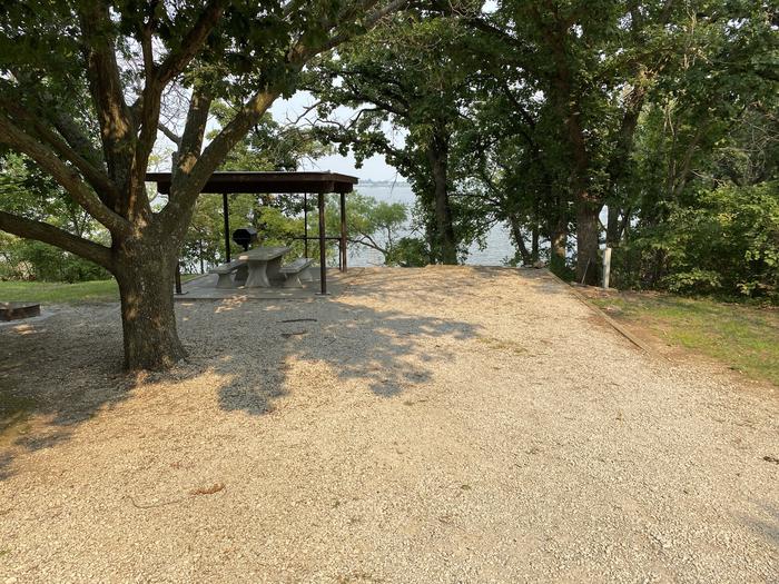 A photo of Site 12 of Loop CCRE at CANNING CREEK with Picnic Table, Electricity Hookup, Fire Pit, Shade, Waterfront, Water Hookup