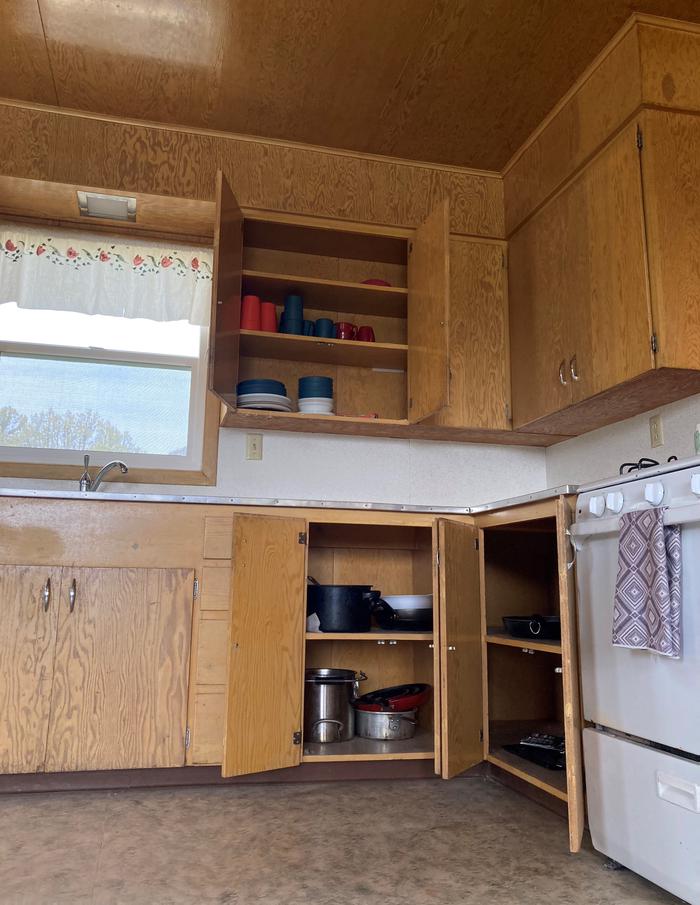 Some basic amenities are stored in the cabinets of both Orange Olsen Dwelling and Cabin.Some basic cooking pans and dining utensils are stored in the cabinets of both Orange Olsen Dwelling and Cabin.