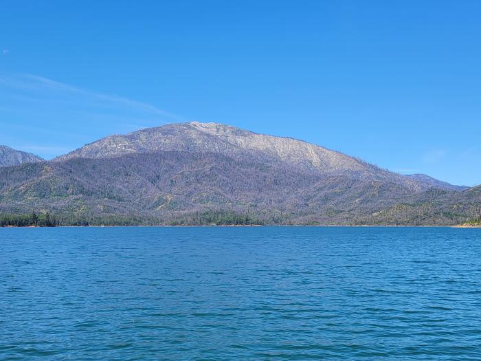 Small ripples on a blue lake with a large mountain in the backgroundEnjoy the waters of Whiskeytown and our amazing views.