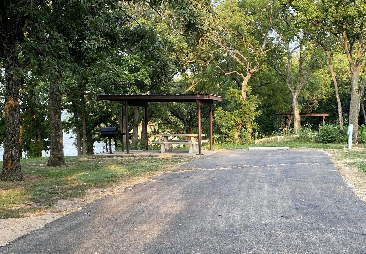 A photo of Site 020 of Loop SFET at SANTA FE TRAIL with Picnic Table, Electricity Hookup, Fire Pit, Shade, Waterfront, Water Hookup