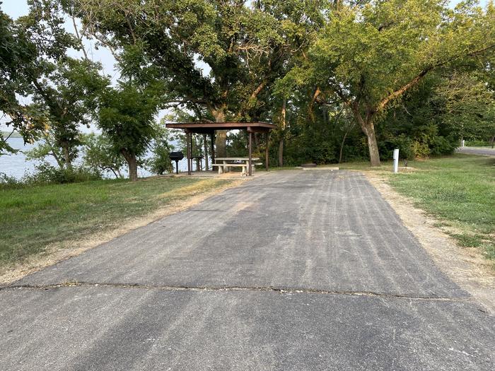 A photo of Site 024 of Loop SFET at SANTA FE TRAIL with Picnic Table, Electricity Hookup, Fire Pit, Shade, Waterfront, Water Hookup