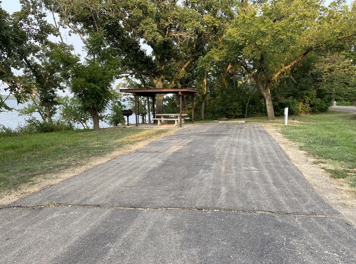 A photo of Site 024 of Loop SFET at SANTA FE TRAIL with Picnic Table, Electricity Hookup, Fire Pit, Shade, Waterfront, Water Hookup