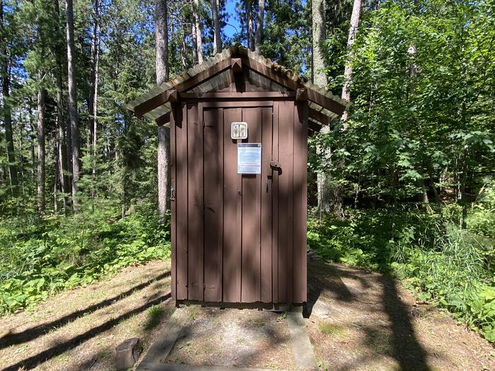 R16 - Kawawia Island, view of wooded outhouse at campsite.Outhouse
