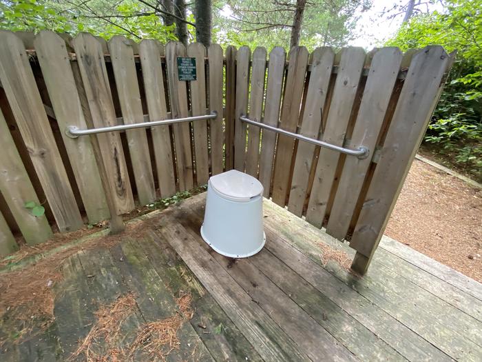 R26 - Sunrise Point, view of privy with handrails attached to privacy guard.Privy with handrails