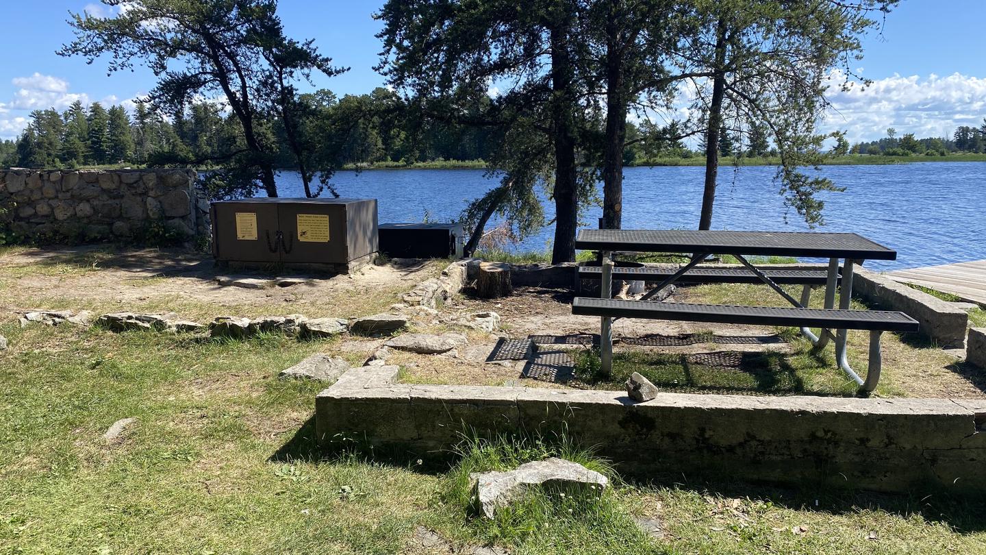 R47 - Whites Point, view looking out from campsite on old cabin foundation with a picnic table and bear box overlooking the water.View looking out from campsite