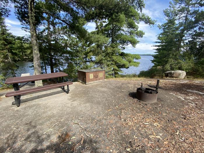 R53 - Makinen Point, view looking out from campsite of the fire ring, picnic table, and bear boxR53 - Makinen Point campsite on Rainy Lake