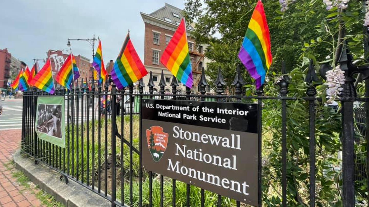 Stonewall National Monument exterior fence with rainbow flagsStonewall National Monument