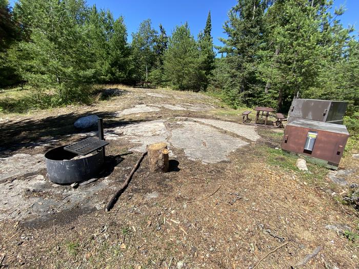 R61 - Harrison Bay, view looking into campsite of the fire ring, bear boxes, and picnic table.View of campsite