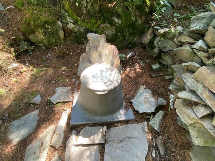 R61 - Harrison Bay, privy at campsite with rock privacy guard.Privy