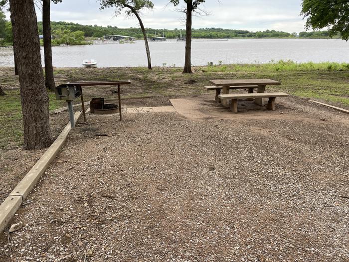 A photo of Site McFadden Cove 8 of Loop McFadden Cove at McFadden Cove with Boat Ramp, Picnic Table, Electricity Hookup, Fire Pit, Shade, Tent Pad, Waterfront, Water Hookup