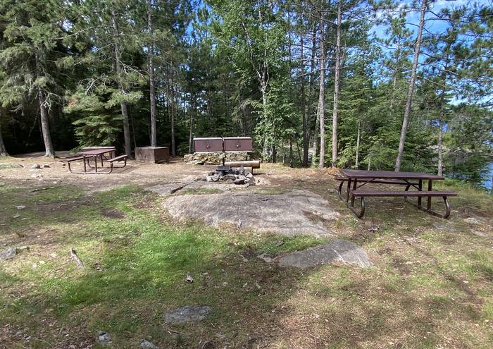 R63 - Loon Bay, view looking into campsite of the fire ring, picnic table, and bear boxes.View of campsite