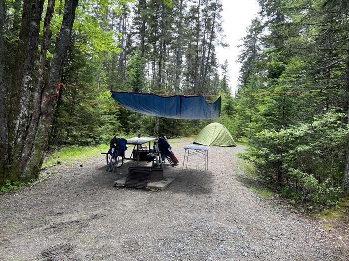Site B8 with small tent and tarp over picnic table