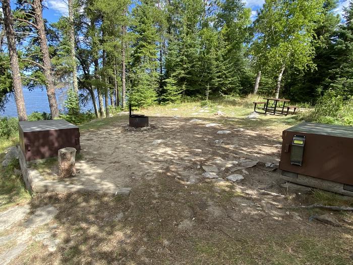 R71 - Loon Cove, view looking into campsite of the bear boxes, fire ring, and picnic table.View of campsite