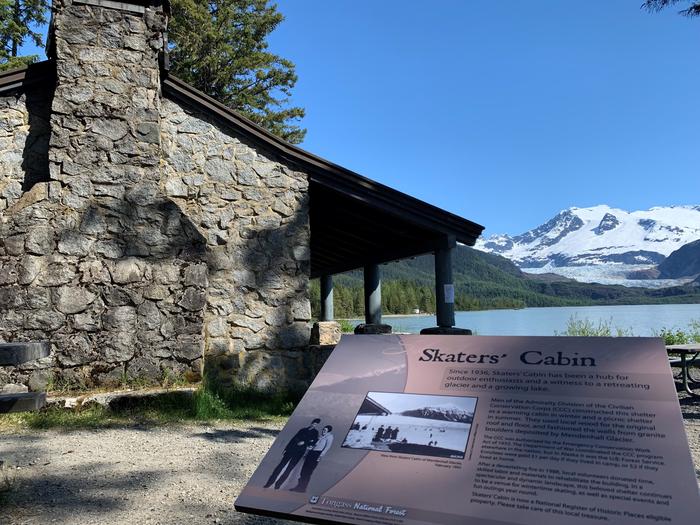 Interpretive sign outside stone cabinInterpretive panel providing history of the CCC-era cabin