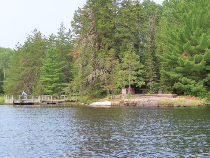 N41 - Voyageurs Narrows, view of campsite from water with boat dock.View of campsite from the water