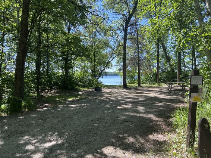 A photo of Site 028 of Loop NORT at ONEGUME with Picnic Table, Electricity Hookup, Fire Pit, Shade, Waterfront