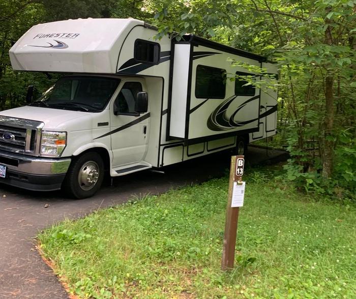 A blacktop surface with a white and black camper.