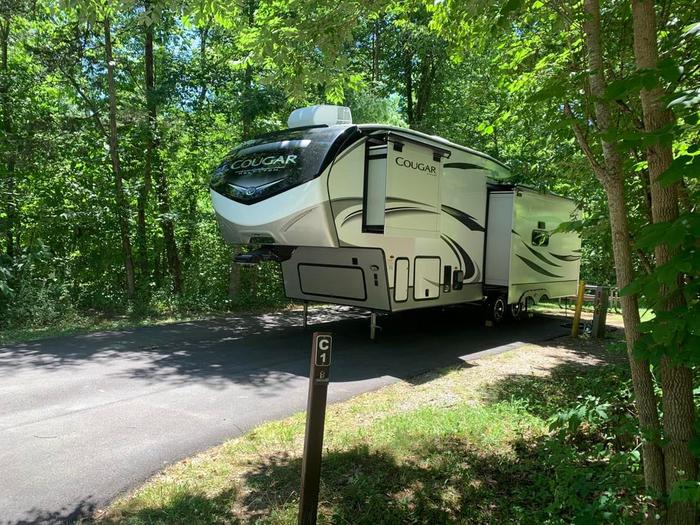 A blacktop surface with a white and black camper.