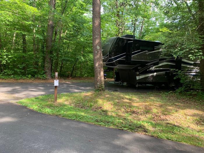 A blacktop surface with a black camper.