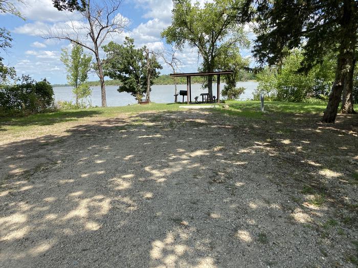 A photo of Site 014 of Loop RCOV at RICHEY COVE with Picnic Table, Electricity Hookup, Fire Pit, Shade, Waterfront