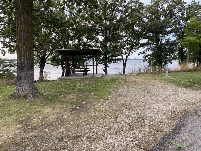 A photo of Site 015 of Loop RCOV at RICHEY COVE with Picnic Table, Electricity Hookup, Fire Pit, Shade, Waterfront