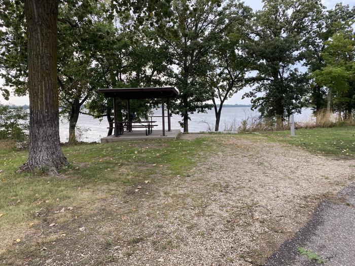 A photo of Site 015 of Loop RCOV at RICHEY COVE with Picnic Table, Electricity Hookup, Fire Pit, Shade, Waterfront