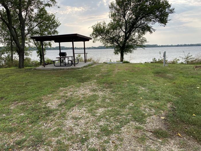 A photo of Site 016 of Loop RCOV at RICHEY COVE with Picnic Table, Electricity Hookup, Fire Pit, Shade, Waterfront