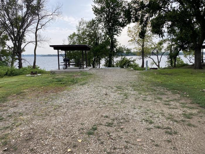 A photo of Site 018 of Loop RCOV at RICHEY COVE with Picnic Table, Electricity Hookup, Fire Pit, Shade, Waterfront