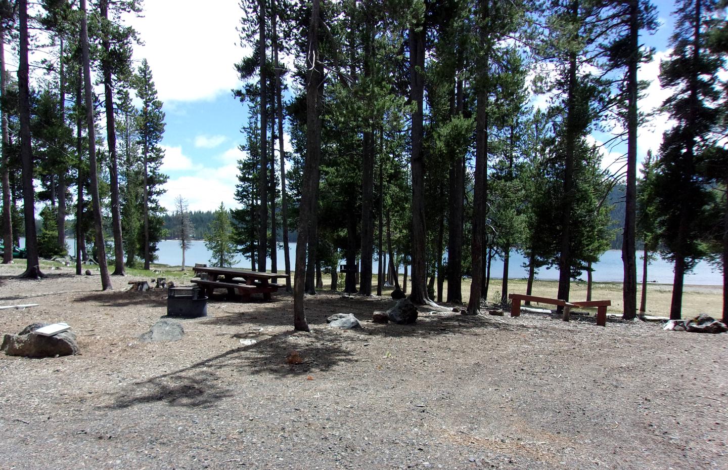 Lakefront with campfire ring, table and grillSite # 15 at Medicine Lake Campground