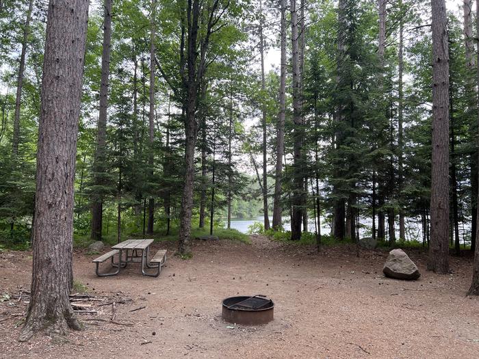 A photo of Site 014 of Loop BOOT LAKE CAMPGROUND at BOOT LAKE CAMPGROUND with Picnic Table, Fire Pit, Shade, Waterfront