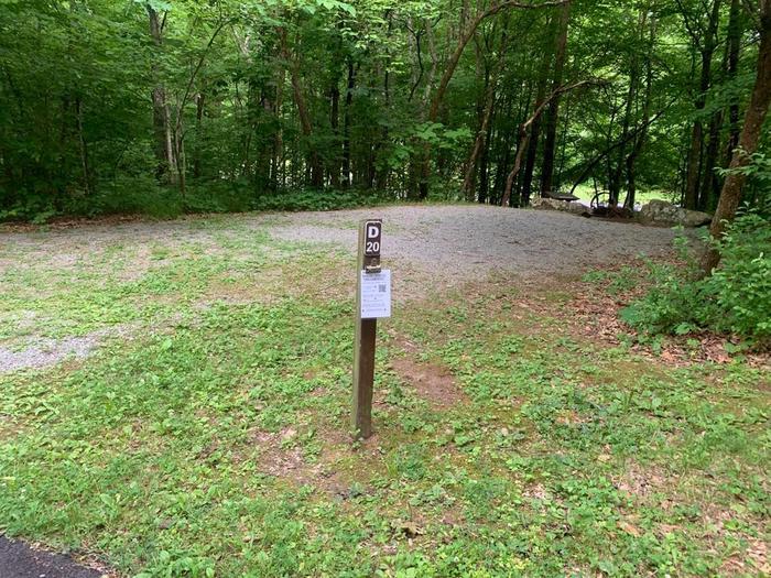 A gravel area with a small brown post.D-20 camping space.
