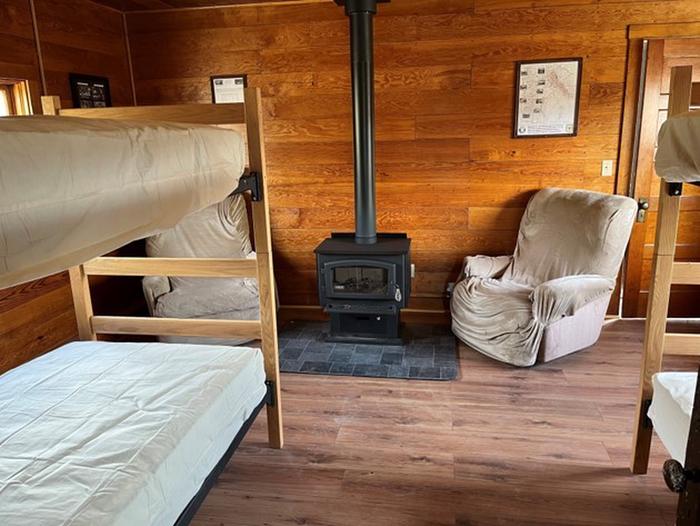 look in from the kitchen area, wood stove, bunk beds and front door.new wood stove, new mattress and covers,