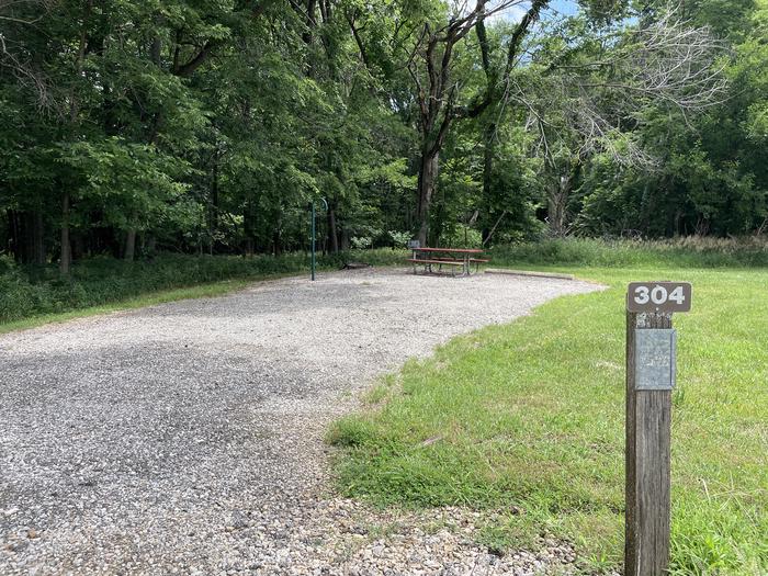 A photo of Site 304 of Loop OAK CAMPGROUND at BLOOMINGTON EAST  with Picnic Table, Fire Pit, Shade, Lantern Pole