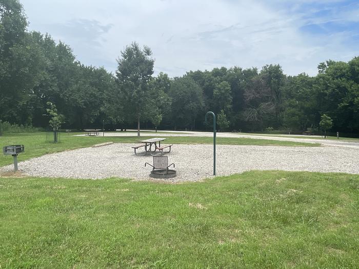 A photo of Site 308 of Loop OAK CAMPGROUND at BLOOMINGTON EAST  with Picnic Table, Fire Pit, Shade, Lantern Pole