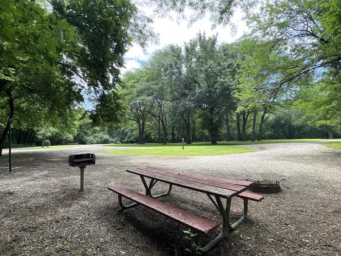 A photo of Site 321 of Loop OAK CAMPGROUND at BLOOMINGTON EAST  with Picnic Table, Fire Pit, Shade, Lantern Pole